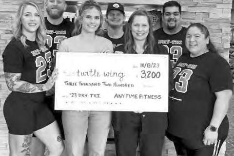 TURTLE WING RECEIVES CHECK FROM ANYTIME FITNESS