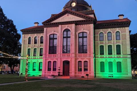 The Colorado County Courthouse displayed green and red lights as part of the courtyard decorations.