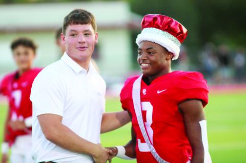 Last year’s homecoming king Conner Geisler passes on the honor to Ty’Vone Whitehead.