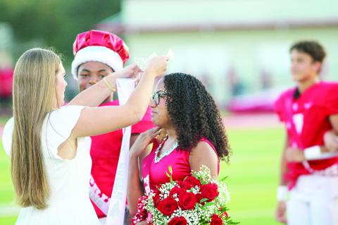 Last year’s homecoming queen Mayson Post passes on the honor to Jayda Ramirez.