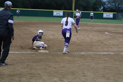 Kaelyn Williams slides into third base after tag up to a pop up