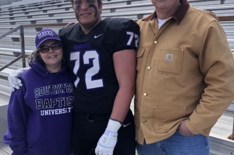 Wade Moore (Middle) taking a picture with his mom Melanie (left) and dad Todd after a game at Southwest Baptist University. Courtesy photo